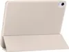 A beige tablet case is shown standing upright, propped up by its folded cover. Náhľad obrázku produktu
