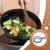 A person is cooking shrimp and broccoli in a wok with a wooden spatula. Náhled obrázku produktu