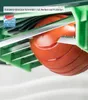 A close-up view of a tomato being sliced by a kitchen gadget. Anteprima dell’immagine prodotto