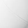 A close-up view of white material with stitching. Produktbild-Vorschau