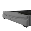Close-up of the side of a gray upholstered bed frame, showing the storage drawers and the slatted mattress support. Náhľad obrázku produktu