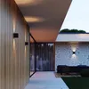 Modern outdoor lighting on a wooden wall and stone wall. Voir les images du produit