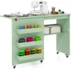 A sewing table with a sewing machine and various sewing supplies. Anteprima dell’immagine prodotto
