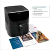 A black air fryer is shown with several accompanying documents, including a recipe book and instruction manuals. Produktbild-Vorschau