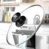 A close-up shot of a pot lid handle against a blurred kitchen background. Anteprima dell’immagine prodotto