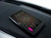 A navigation device is placed on a car dashboard. Voir les images du produit