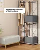 A clothes rack with clothes and storage boxes, next to a bench. Produktbild-Vorschau