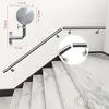 A stainless steel handrail mounted on a wall next to a staircase. Produktbild-Vorschau