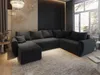 A modern living room with a large sectional sofa, a chandelier, and a large window.