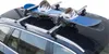A snowboard and bindings are mounted on a car's roof rack. Podgląd zdjęcia produktu