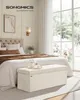 A bedroom scene with a bed, blanket, pillows, and a storage bench. Náhled obrázku produktu