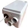 A white wastewater pump unit with multiple inlet pipes and a power cord. Voir les images du produit