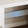 A close-up view of a white desk with a light blue accent bar. Podgląd zdjęcia produktu