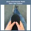 A person is holding a black sock, showing the toe area. Produktbild-Vorschau