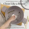 A hand is cleaning a pot with oil in it, with text overlays highlighting product features. Produktbild-Vorschau