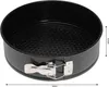 A black round cake pan with a silver latch mechanism is shown from a slightly elevated side angle against a white background. Dimensions are indicated by arrows and text. Náhled obrázku produktu