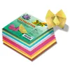 A stack of colorful origami paper with a sample origami figure on top. Podgląd zdjęcia produktu