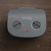 A gray Rowenta Instant Comfort Compact heater is shown from a top-down perspective on a wooden surface. Voir les images du produit