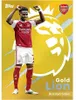 A soccer player in an Arsenal kit is shown celebrating with his hands raised, against a yellow background with a large graphic of a lion's head and the Premier League logo. Podgląd zdjęcia produktu