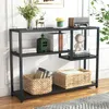A black metal console table with shelves, decorated with various items like books, baskets, and decorative objects.
