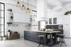 A modern kitchen with a large island, white cabinets, and industrial-style pendant lights. Voir les images du produit