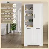 A white bathroom cabinet with open shelves and closed cabinets, filled with various toiletries and rolled towels. The background shows a bathroom setting with a bathtub and wooden flooring. Podgląd zdjęcia produktu