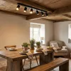A dining room with a wooden table and chairs, illuminated by a ceiling light fixture. Náhľad obrázku produktu