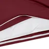 A close-up view of a burgundy duvet cover with a white trim, partially opened to reveal a white duvet inside. Produktbild-Vorschau