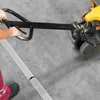 A person is using a pallet jack to move a long, segmented object on a concrete floor. Anteprima dell’immagine prodotto