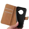 A hand holding a black flip phone case with a brown interior. Produktbild-Vorschau