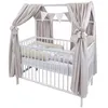 A white baby crib with a canopy and bedding. Produktbild-Vorschau