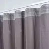 A close-up view of several gray curtains hanging from a white curtain rod. Produktbild-Vorschau