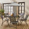 An outdoor dining set with a table, chairs, and umbrella on a wooden deck. Anteprima dell’immagine prodotto