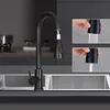 A black kitchen faucet is shown in a kitchen setting, with inset images demonstrating its pull-down spray function. Anteprima dell’immagine prodotto