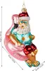 A glass Christmas ornament of Santa Claus riding a pink flamingo pool float. Voir les images du produit