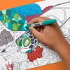 A hand is coloring a picture of a sea turtle with a green Sharpie marker. Voir les images du produit