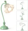 A flower-shaped desk lamp shown from multiple angles. Produktbild-Vorschau