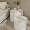 A living room scene with a sofa, two round coffee tables, and a vase with greenery. Anteprima dell’immagine prodotto