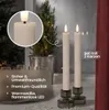Two LED candles in candle holders are displayed on a surface, with a small Christmas tree and fairy lights in the background. A close-up of one candle is shown in a circle. Produktbild-Vorschau