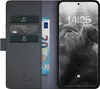 A black leather flip case for a smartphone, with cards and a banknote inserted. Produktbild-Vorschau