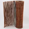 A rolled-up and unrolled willow matting fence on a white background. Produktbild-Vorschau