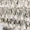 A close-up view of a crystal chandelier or light fixture, showing multiple tiers of faceted crystal pendants. Anteprima dell’immagine prodotto