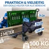 A person is loading a cart with crates of beer bottles and wooden planks. Podgląd zdjęcia produktu