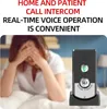 A person is in bed with their hands over their face, next to a wireless intercom device. Podgląd zdjęcia produktu