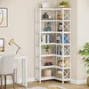 A white corner bookshelf filled with books and decorative items, next to a desk with a lamp and chair. Náhled obrázku produktu