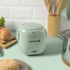 A mini rice cooker is shown on a kitchen counter with other kitchen items. Produktbild-Vorschau