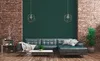A living room scene with a sectional sofa, coffee table, and brick walls. Produktbild-Vorschau