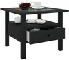 A black side table with a drawer and a shelf, featuring a decorative top and a bowl of red berries, a white cup and saucer, and a white decorative sphere. Voir les images du produit