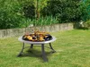 A fire pit with flames burning in a grassy backyard with a concrete wall and bushes in the background. Produktbild-Vorschau