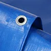 A close-up view of a blue tarp with a metal grommet. Produktbild-Vorschau